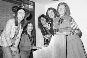 Slade stars Dave Hill, Jim Lea, Don Powell and Noddy Holder are joined around the piano by Vera Lynn at the 1973 Melody Maker Awards