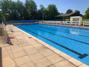 Supporting image for story: Volunteers splash a few finishing touches on village's outdoor pool