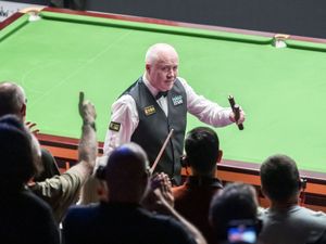John Higgins celebrates after beating Xiao Guodong, (Danny Lawson/PA)