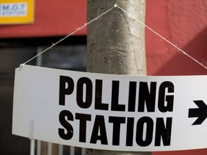 A sign pointing to a polling station