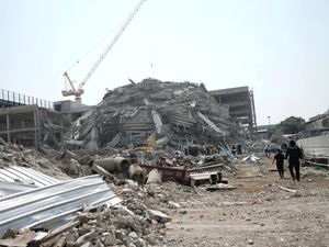 Rescuers work at the site of a high-rise building under construction that collapsed after an earthquake hit Thailand