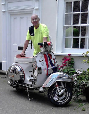 Kenny Barber poses with a Vespa in Tenby in 2011