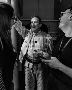 Tam Ryan shares a laugh with people backstage. Photo: Danny Kaan