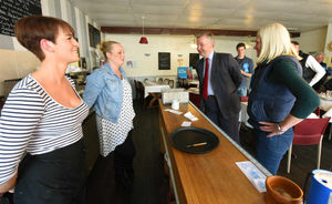 Mr Gove chats to Rose's Cafe manager Victoria Gisbourne, and staff member Hannah Pratt, with Tory candidate Amanda Milling