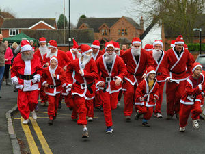 Supporting image for story: Not a sleigh in sight as Santas dash around village - video