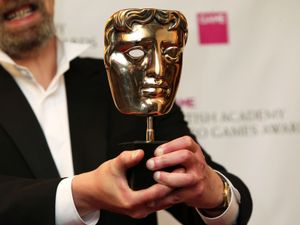 A winner’s Bafta mask is held up