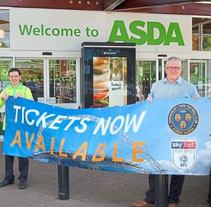 Staff outside Asda in Old Potts Way display a banner