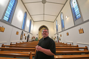 Father Craig Fullard from the Newman cluster of churches with the restored ceiling