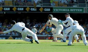 Australia's Mitchell Johnson hits a shot past England's Ian Bell (left)
