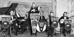 Fred Russon, playing the piano, around 1920.