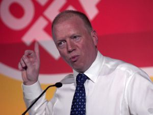 Matt Wrack gesturing and speaking into a microphone