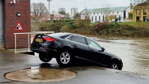 An image shows the black Audi A4 that was left dangling over the River Severn at Worcester Rowing Club on December 1 2025.