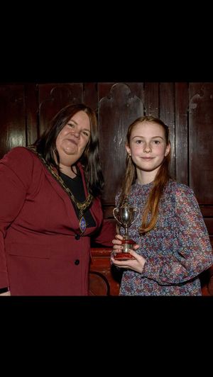 Rosie Naylor James receives the Richard Bean Memorial Trophy from the Mayor.