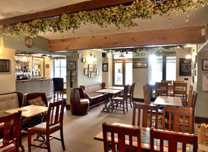 Stripped back wooden tables and a well-lit bar