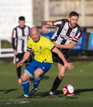 Captain Michael McGrath challenges for the ball. Pic: Jim Wall