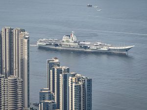 Supporting image for story: Chinese aircraft carrier sails into Hong Kong to boost patriotism