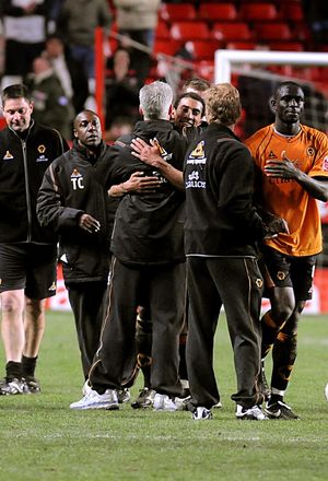 
Karl Henry gets a hug from manager Mick after the match.