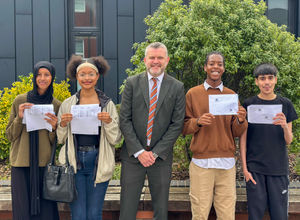 A proud moment: Principal Thomas Daly celebrates alongside students on GCSE results day.