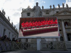 A giant screen in St Peter’s Basilica shows cardinals inside the Sistine Chapel during the conclave