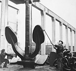 February 10, 1960, the caption reads: 'This giant 10-ton Dreadnought-type anchor is one of three being made by the firm Samuel Taylor and Sons (Brierley Hill), Ltd., for the 45,000-ton liner Canberra, being built at Belfast. The ship is to be launched by Dame Patti Menzies in March.'