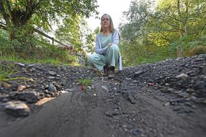 CANNOCK COPYRIGHT  NATIONAL WORLD TIM STURGESS 09/09/25 Kaye Le Page shows the hole in the road near Sladespring Lodge site off Camp Road