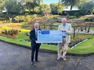 The former mayor of Shrewsbury David Vasmer (left) presents Omega with a cheque