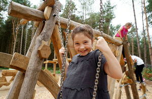 A child playing on the play area within the Pedal and Play at Cannock Chase Forest