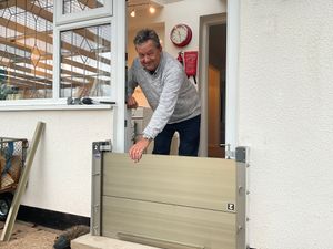 Tony Thorn with one of the flood defences installed to protect the doors to his home at Caersws.