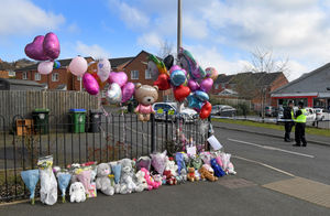 The tributes went around the fence at the edge of Robin Close