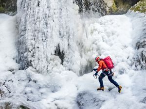 Supporting image for story: Man scales frozen waterfall in national park amid ‘very rare’ conditions