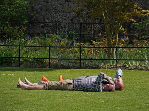 People relax in Westgate Gardens, Canterbury, Kent, during the sunny weather