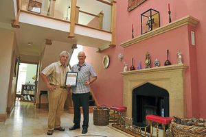 Malcolm Bennett and Mike Speed show off the interior of the house and the award they have receieved for the build