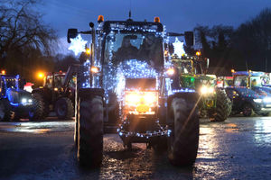 Organisers Georgina Synnock-Morigan and Rae Morgan in their illuminated tractor leaving the Cattle Market. Image by Andy Compton