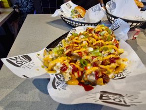 The Hot Mess dishes combine sauces, fries and chicken in a delicious mess