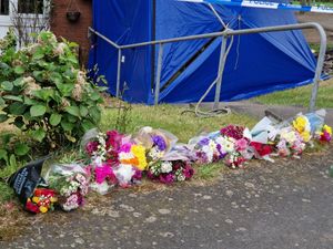 Tributes have been left at the scene of a fatal fire where two women have died