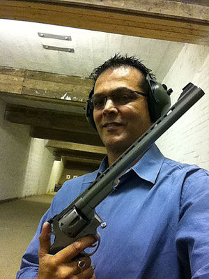 Middleman Dr Mohinder Surdhar with a gun