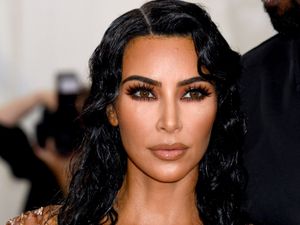 Supporting image for story: Kim Kardashian wears black dress with Balenciaga price tag left on