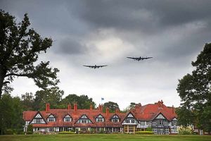Two Lancaster bombers fly over Petwood Hotel as the RAF ensign flutters in the breeze