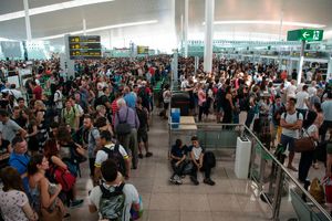 Passengers gather as they wait for passing the security controls at Barcelona's El Prat airport. (Photo credit should read JOSEP LAGO/AFP via Getty Images)