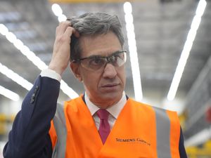 Ed Miliband in a high-vis jacket and protective goggles