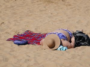 A woman sunbathing on the beach at Margate