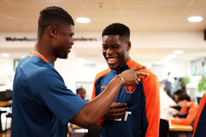 Marshall Munetsi of Wolverhampton Wanderers (R) embraces Emmanuel Agbadou as he arrives at  (Photo by Jack Thomas - WWFC/Wolves via Getty Images)