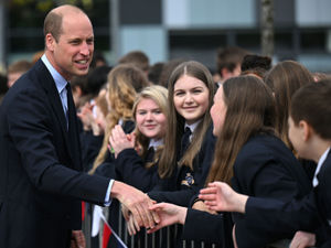 The Prince of Wales speaks with schoolchildren after his visit to St Michael's Church of England High School in Rowley Regis