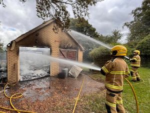 Supporting image for story: Fire destroys garage with thick smoke visible for miles