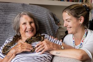 Jenny Telfer, 94 (Resident) and Kerry Butts (Activities Lead) with “Bob” a Royal Python
