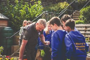 Adlington Retirement Living's garden design expert, James King, shows children how to make a bug hotel