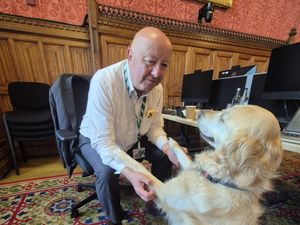MP Steve Darling sitting with his guide dog Jennie