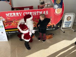 A little girl gives her Christmas wish list to Santa in Hednesford
