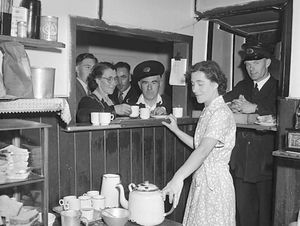 Circa August 1952: 'Old folks tea party given by the canteen ladies of the Midland Red Bus Company.' This picture is from the Geoff Charles Collection at the National Library of Wales