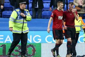 Chris Brunt, right, walks off after the incident at the end of the tie